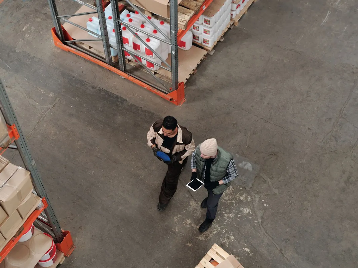 Two people walking a warehouse floor with a tablet, drawing the chain in the company's own words.